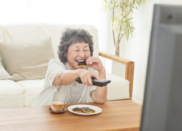 シニアがテレビの音量を上げて楽しむ様子